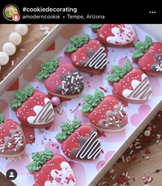 decorated heart shaped cookies in a box on a table