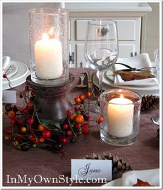 a table set with candles and place cards