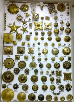 there are many different types of buttons on this display case, and all in gold