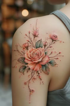 a woman's shoulder with flowers and leaves painted on the upper half of her arm