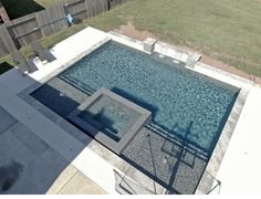 an aerial view of a swimming pool in a backyard