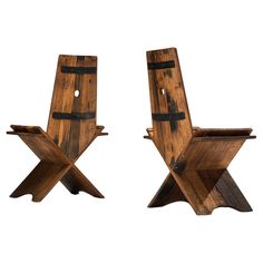 two wooden chairs sitting next to each other