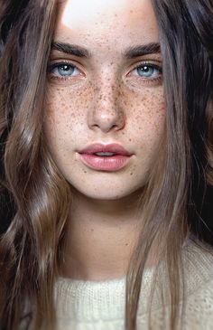 a woman with freckled hair and blue eyes