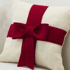 a pillow with a red bow on it