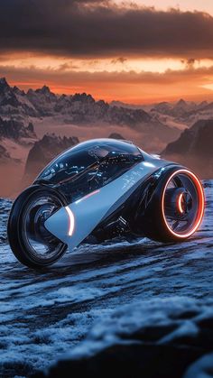 a futuristic car is shown in the middle of a snowy mountain range at sunset or dawn