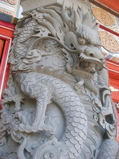 a dragon statue on the side of a building