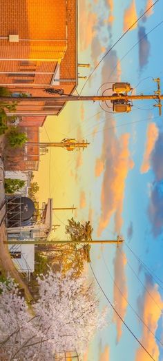 the sky is reflecting in the water and clouds are reflected on the ground, along with power lines