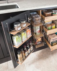 an open cabinet in a kitchen filled with food