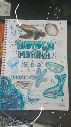 an open notebook with drawings on it and the words molokna marina written in cursive writing