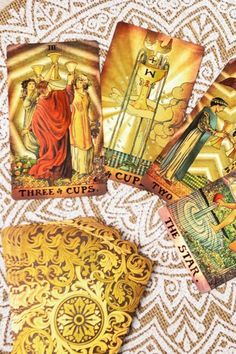 four tarot cards with the image of jesus and mary on them, all in gold