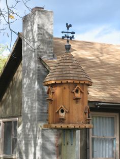 a bird house on top of a wooden pole