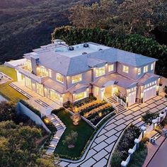 an aerial view of a large home in the hills