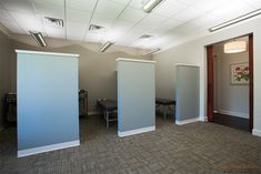 an empty room with three partitions in it