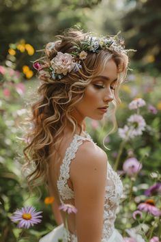 a woman with long hair and flowers in her hair, wearing a wedding dress surrounded by wildflowers