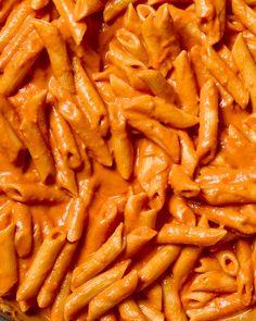 a bowl filled with pasta and sauce on top of a table