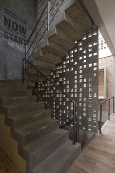 the stairs are made out of concrete blocks and steel bars, along with wood flooring