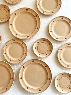 a table topped with lots of brown plates