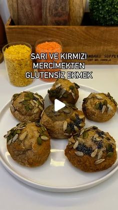 a white plate topped with muffins on top of a table next to carrots