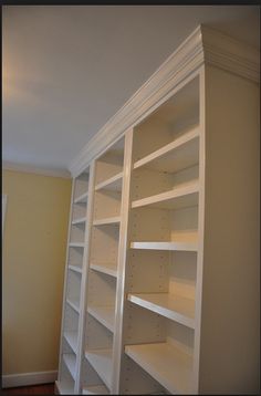 an empty white book shelf in a room