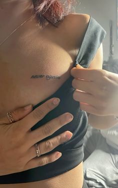 a woman with tattoos on her chest and hand