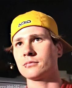 a young man wearing a yellow hat with the word aoia on it's side