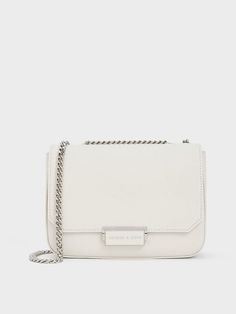 This product is made with at least 20% sustainable materials by weight. CHARLES & KEITH uses recycled, degradable, organic, and water-based materials in our eco-conscious collection. White and silver make for a timelessly chic combination, especially when seen on this classic chain strap shoulder bag. It is roomy enough to hold all your daily essentials when you are on the go, while looking clean, compact and polished. Reach for this to instantly elevate your white tee and jeans ensemble - it is the perfect companion for errand runs and lunch breaks. White Tee And Jeans, Size Chart For Kids, Charts For Kids, Charles Keith, Daily Essentials, Printables Kids, White Tee, Belt Size, White Bag