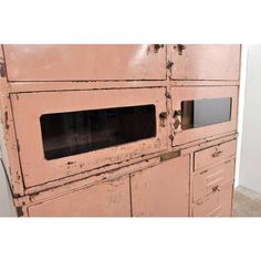 an old pink stove with two oven doors