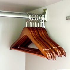 wooden clothes hangers hanging on a white wall