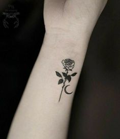 a small rose tattoo on the wrist