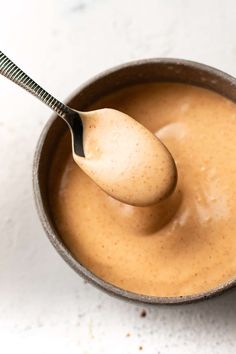 a spoon full of peanut butter in a bowl