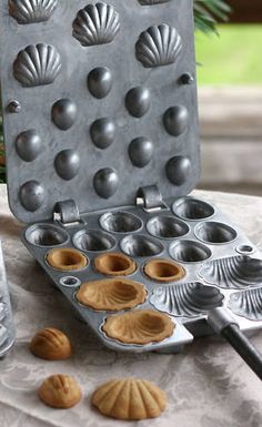 an assortment of pastries on a table with utensils in front of them