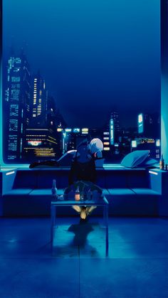 a person sitting on a bench in front of a cityscape at night time