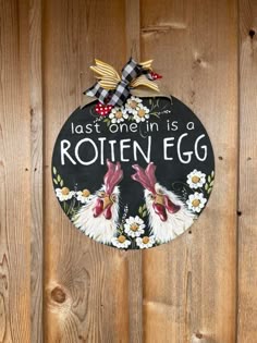 a sign on the side of a wooden fence that says, last one in is rotten egg