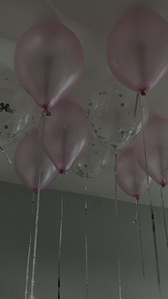 pink balloons hanging from the ceiling in a room