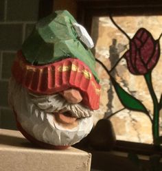 a close up of a gnome's head on top of a piece of cardboard