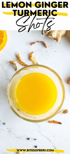 lemon ginger tumeric shots in a glass on a white table with orange peels