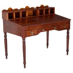 an antique wooden desk with drawers and legs