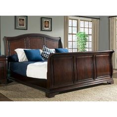 a bedroom with a bed and dresser in it