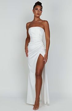 Make an entrance in Safiya, our sleek satin maxi gown that hugs the body in all the right places. Designed with a hidden corset to cinch the waist, the dress features a strapless cut, drape detail to the bust and a thigh high split. Wear yours with a high knot, long mesh gloves and simple mule heels.



Colour: Ivory. 

Luxury heavy stretch satin. 

Thigh high split. 

Body hugging fit. 

Hidden corset. 

Drape detail. 

Strapless cut. 

Maxi length.

Model is a size XS and is wearing an XS. Babyboo Fashion, Homecoming Dresses Corset, White Dress Spring, Midi Dress Wedding Guest, Long Sleeve Homecoming Dresses, Mesh Gloves, Mule Heels, Maxi Dress Sale, Maxi Gown