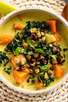 a white bowl filled with soup and vegetables