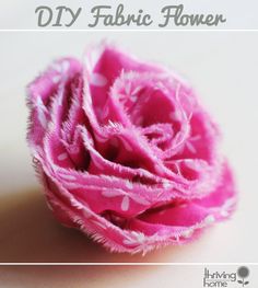 a pink flower with white polka dots on it and the words diy fabric flower