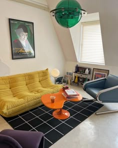 a living room filled with furniture and a green lamp hanging over the top of it