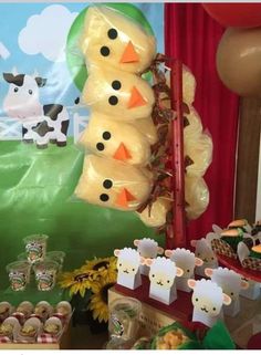 a table topped with lots of desserts and balloons in the shape of snowmen