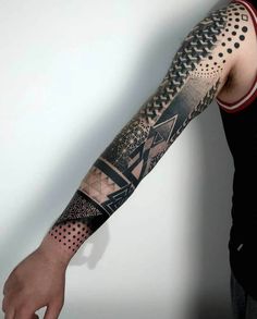 a man's arm with tattoos on it and an abstract design in the middle