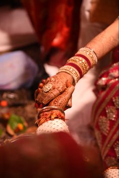 the bride and groom are holding hands