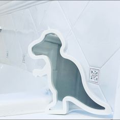 an animal shaped soap dish sitting on top of a bath tub