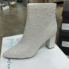 The Cady Is A Disco-Ready Bootie That Will Take Any Outfit You Wear To The Next Level. These Ankle Boots Feature A Pointed Toe And A Study, Block Heel And Are Fully Decked Out With Pearl Rhinestones. Glitz And Glam Have Never Looked Better. Pearl Embellished Booties Side Zipper Closure Textile Lining Betsey Blue Sole 3.5 Inch Heel Height 5.5 Inch Shaft Height White Party Boots With Reinforced Heel, White Closed Toe Party Boots, White Closed-toe Party Boots, White Low Heel Party Boots, White Low Heel Boots For Party, White Block Heel Boots For Evening, Evening White Block Heel Boots, White Rhinestone Boots With Round Toe, White Rhinestone Boots For Spring