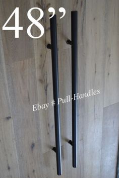 two black metal handles on a wood floor with the words ebay pull - handles