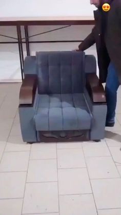 a man is pushing a chair that has been placed on the floor