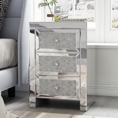 a mirrored chest of drawers in a room with white walls and carpeted flooring